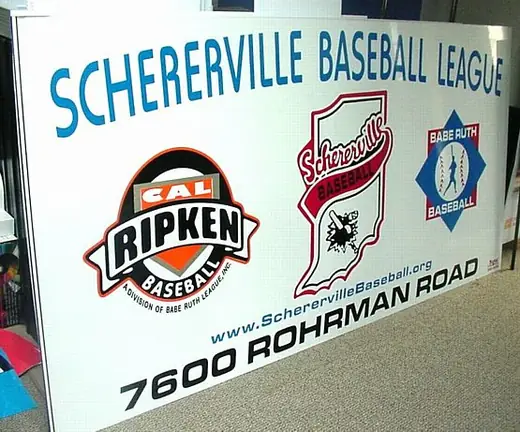 Baseball league building sign with logos and an address number