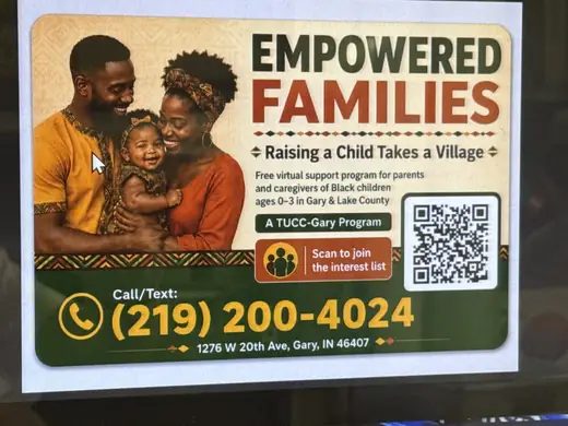 Community organization sign with a phone number and QR code